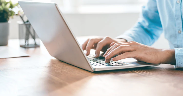 Male using laptop to form digital marketing strategies