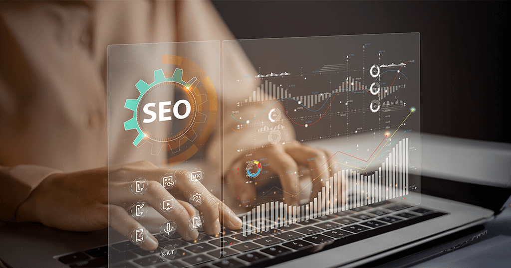 SEO specialist from Verz Design agency working on a laptop with an SEO interface displayed on a virtual screen, including graphs, charts, and analytics icons